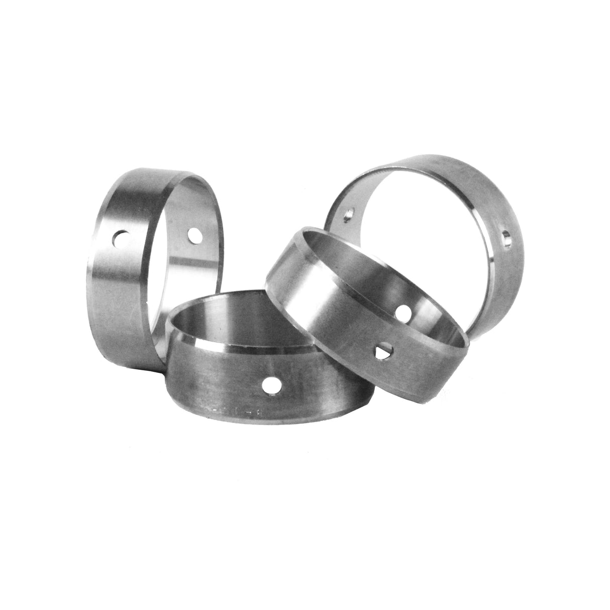 A black-and-white image shows four metal rings of various sizes stacked and leaning against each other, resembling the components found in an Engine Rebuild Kit by Partsology. Each ring has a small circular hole on its surface, and the plain white background emphasizes the metallic texture of the rings.