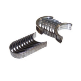 Two sets of metal engine bearings, part of the Partsology Engine Rebuild Kit for a 3.0L V6 DOHC, are arranged side by side on a white background. Each set consists of semi-circular bearing shells aligned in a slightly fanned-out manner, with one set positioned horizontally and the other vertically.